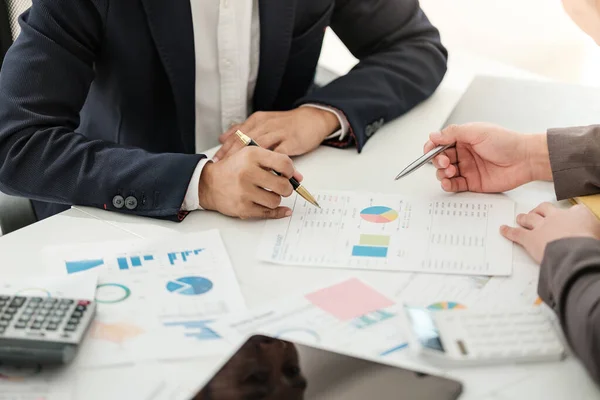 stock image Team of two asian male business people working together discussing new financial graph data on office table with laptop and digital tablet. High quality photo