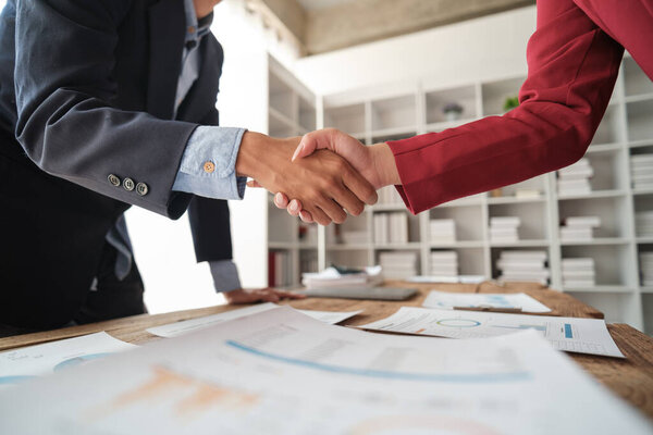Handshake as successful negotiation ending, close-up. Unknown business people shaking hands after contract signing in modern office. High quality photo