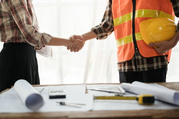 stock image Close-up image of an engineer shaking hands with his coworker during the meeting. teamwork, building trust, unity. High quality photo