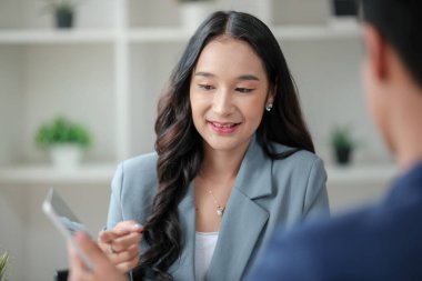 Ofiste masa başında çalışırken gülümseyen iki iş adamı. Yüksek kalite fotoğraf