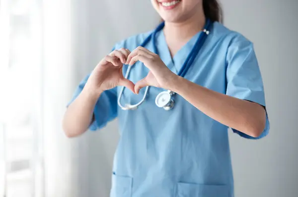 Heart from doctor or nurse hand standing in the hospital office. High quality photo
