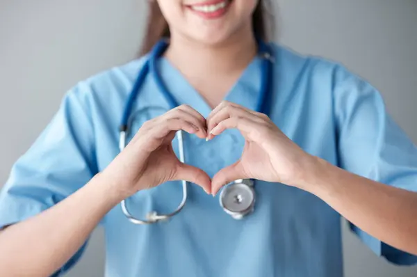 Heart from doctor or nurse hand standing in the hospital office. High quality photo