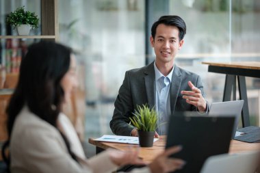 Ofiste masa başında çalışırken gülümseyen iki iş adamı. Yüksek kalite fotoğraf