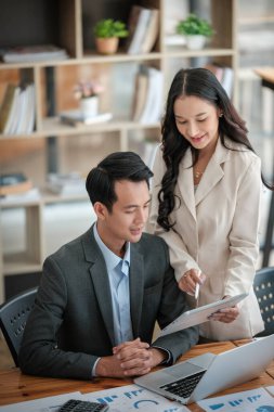 Ofiste masa başında çalışırken gülümseyen iki iş adamı. Yüksek kalite fotoğraf