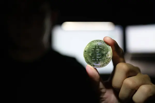 Crypto money bitcoin background. Crypto hacker hand hold golden BTC bit coin. Digital money, stock market concept. High quality photo