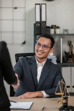 Masa başında çalışan Asyalı avukat bir belge, hukuk ve adalet kavramı yazıyor. Yüksek kalite fotoğraf