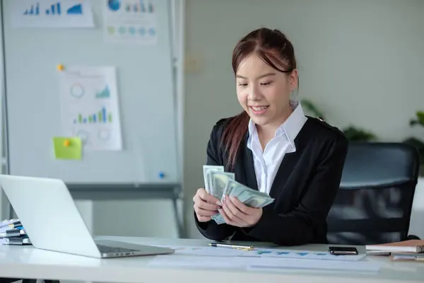 Rich wealthy business woman Asian businesswoman financial bookkeeper girl in an office entrepreneur counting money cash count salary profit finance jackpot earn investment budget dollars banknotes