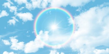 Sun halo in blue sky. Circular rainbow among clouds. Amazing atmospheric phenomenon, refraction of light