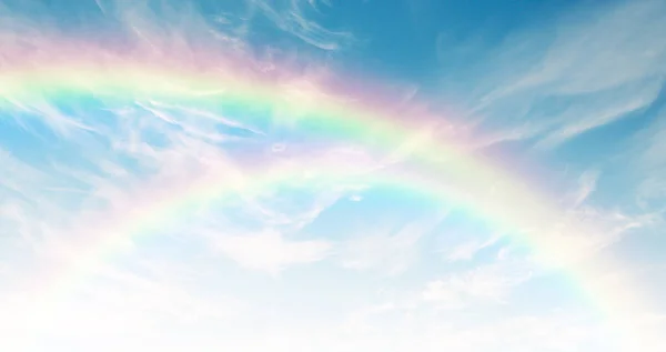 Gorgeous rainbow in the sky. Sky view with thin clouds.