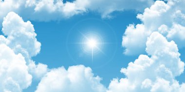 Fluffy white clouds in a bright blue sky. bottom up view of the sunny sky