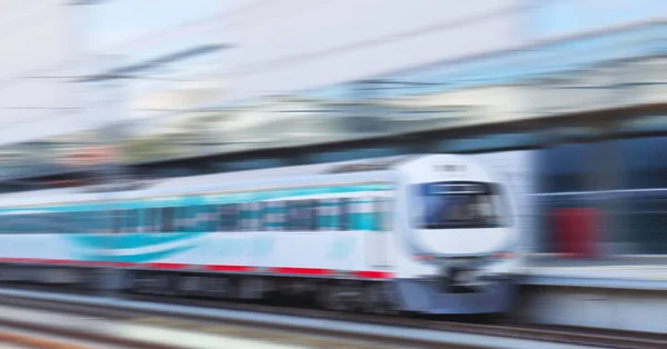 High-speed train in motion at the railway station. Motion blur effect. Commuter train. Intercity passenger train. Transportation, travel concept.