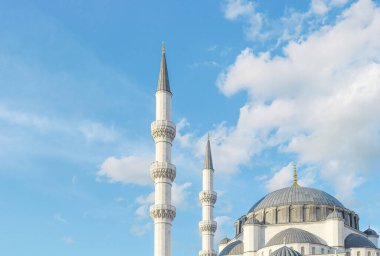 Beautiful blue sky and mosque view in summer. Dome and minarets of a large Turkish-style mosque. Mosque and islamic background image.