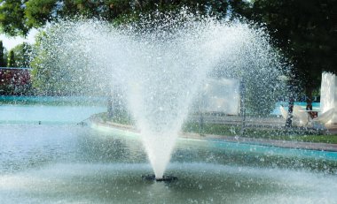 Water gushes up from the fountain in the pool