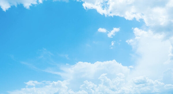 Bright white clouds in clear blue sky early morning on summer day