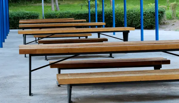 stock image Empty wooden benches for resting in a public park.