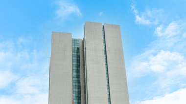 Mavi gökyüzü arka planında çok katlı yüksek gökdelenin dış görünümü.