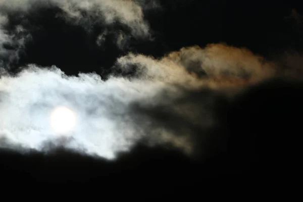 stock image Sun disk behind backlit clouds