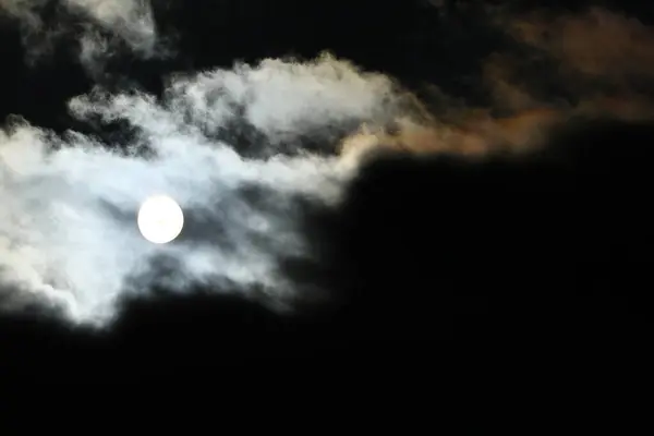 Stock image Sun disk behind backlit clouds