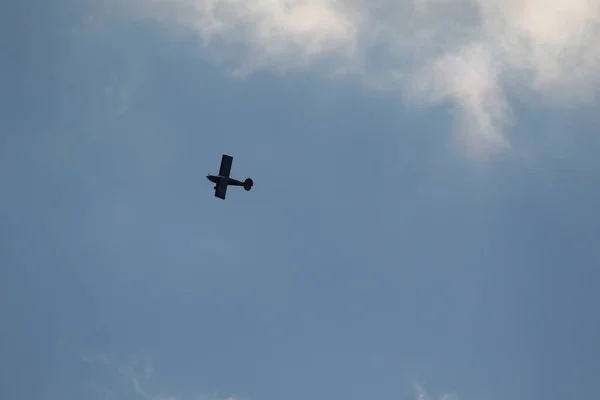 Small plane flying on a blue sky
