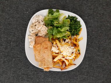 Ev yapımı ızgara tavuk ızgara kabak, yeşil salata, patates kızartması, peynir ve maydanoz.