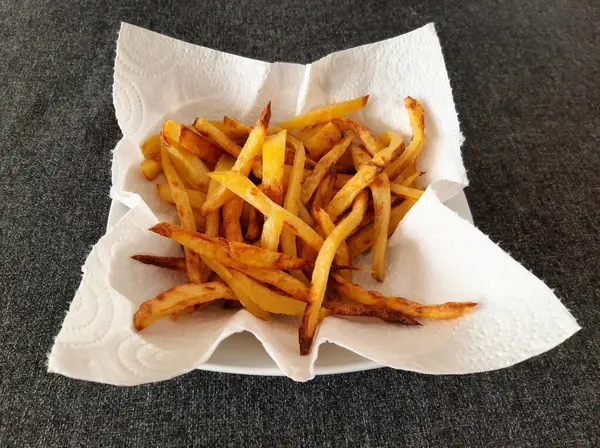 French fries on white paper kitchen towel