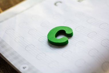 English alphabet made of square wooden tiles with the English alphabet scattered on hand. The concept of thinking development, grammar