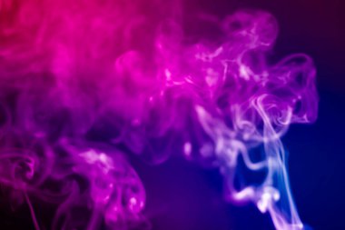 Colorful smoke on a black background. Rainbow abstract light texture smoke background. clipart