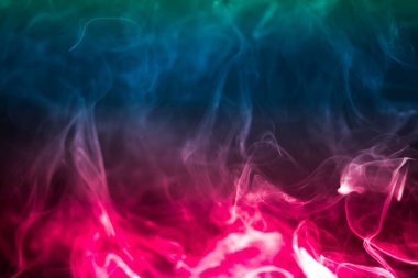 Colorful smoke on a black background. Rainbow abstract light texture smoke background.