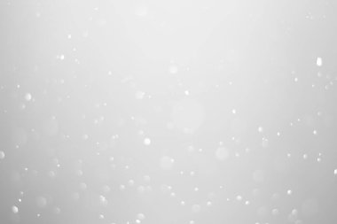 White glitter vintage lights background.  White bokeh shiny on dark background.