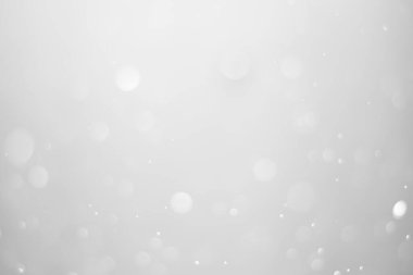 White glitter vintage lights background.  White bokeh shiny on dark background.