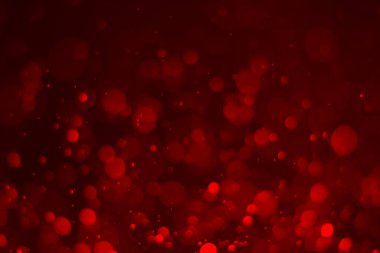 Kırmızı parıltılı klasik ışık arka planı. kırmızı bokeh koyu arkaplanda parlıyor.