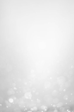 White glitter vintage lights background.  White bokeh shiny on dark background. Vertical photos