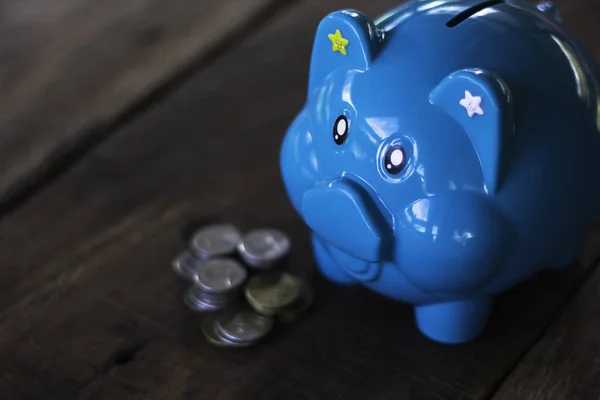 Blue piggy bank on table