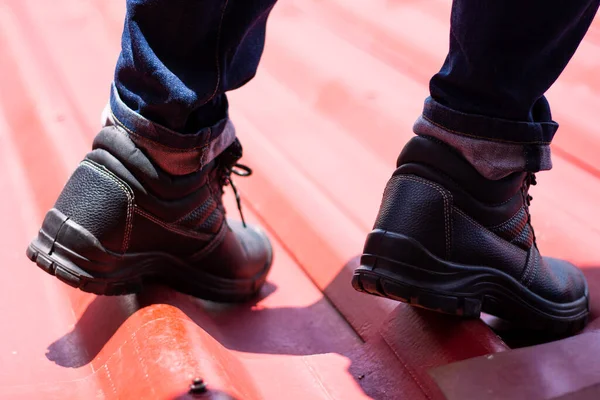Wear safety shoes to ensure safety at work. construction workers wear safety shoes. concept working at height