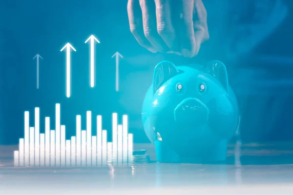 Blue piggy bank on wood table. Saving and investing concepts, Planning to collect money for investment