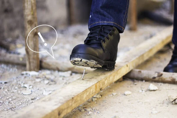 Wear safety shoes for work safety. Construction workers wear safety shoes and have digital icons warning of safety.