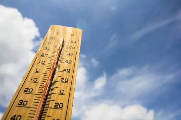 stock image The background thermometer is a blue sky. global warming content