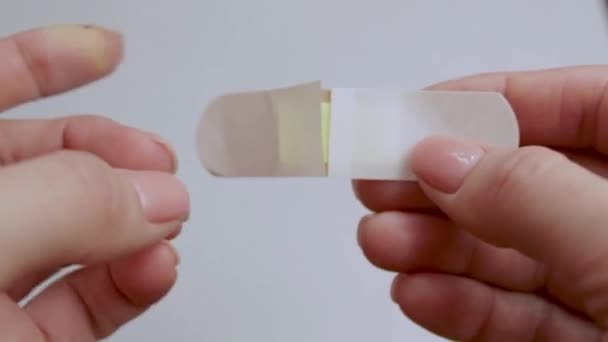 Man Opens Adhesive Plaster First Aid Trauma Medicine Isolated Background — Stock Video