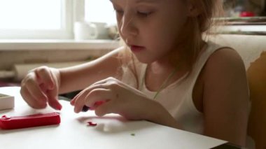 Cute little girl sculpts from plasticine. Educational activities for the home. Development of fine motor skills. Imagination game. Video.