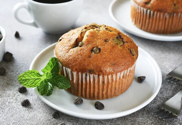 Muffin with chocolate chips and a cup of coffee. Morning and breakfast time.