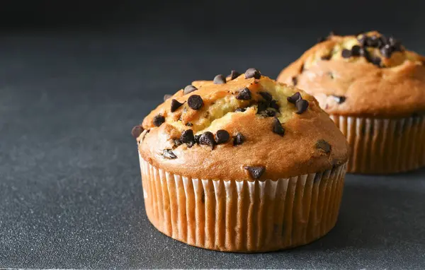 Muffins with chocolate chips on a dark background