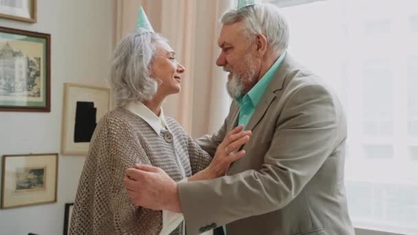 Elderly Couple Hugging Greeting Each Other Birthday Party Pastel Coloured — Stock Video