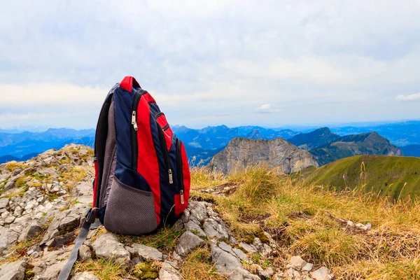 stock image Tourist backpack on background of mountains in Swiss Alps. Travel outdoor concept