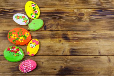 Egg shaped easter gingerbread cookies on wooden table. Top view, copy space. Sweets for celebrate Easter