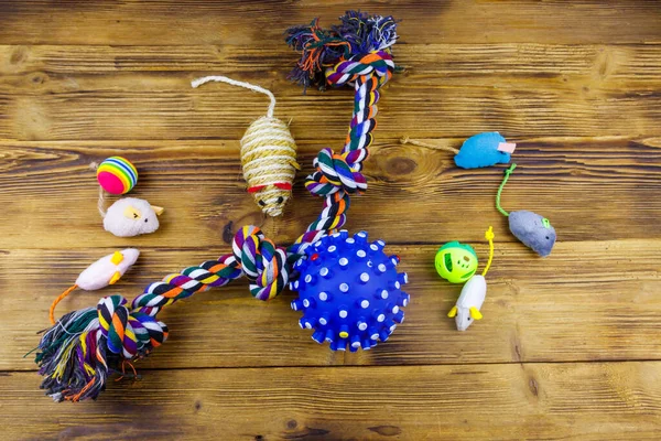 Set of toys for cats and dogs on wooden background. Top view