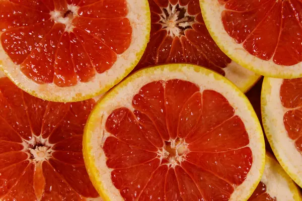 stock image Fresh slices of grapefruits as background