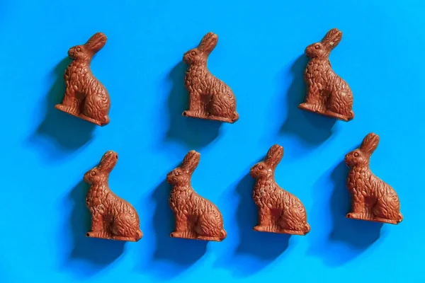 stock image Easter chocolate bunnies on blue background. Top view