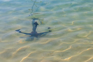 Okyanus kıyısında küçük bir tekne çapası.