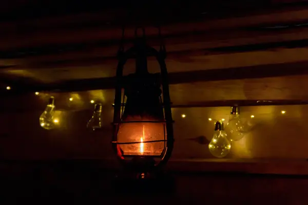 Vintage gas lamp with burning light in the night