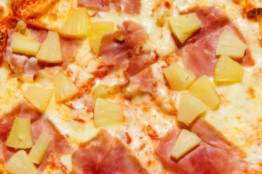 Texture of a delicious fresh hawaiian pizza with sausage, pineapple and cheese